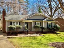 Charming single-story home with a well-manicured lawn and neat landscaping at 21228 Pine Ridge Dr, Cornelius, NC 28031