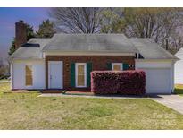 Charming brick home featuring a well-maintained lawn and a delightful splash of greenery at 3701 Teaberry Ct, Charlotte, NC 28227