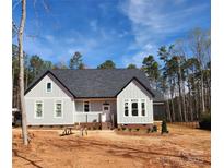 Charming, single-story home with gray siding, a dark roof, and a manicured lawn at 409 Henry Chapel Rd, Belmont, NC 28012