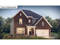 Beautiful two story home featuring brick and siding details, manicured lawn, and a two car garage at 1029 Merganser Way, Indian Trail, NC 28079