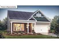 Charming home with a mix of brick and siding, a well-manicured lawn, and a welcoming two-car garage at 1055 Merganser Way, Indian Trail, NC 28079