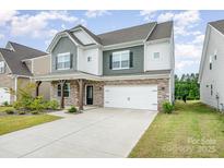 Charming two-story home with a two-car garage, covered porch and nicely landscaped front yard at 16200 Winfield Hall Dr, Charlotte, NC 28273