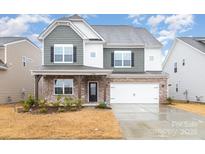 Charming two-story home featuring a mix of stone and siding, complemented by a well-manicured front yard at 16200 Winfield Hall Dr, Charlotte, NC 28273