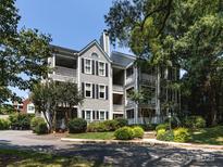 Attractive multi-story condo with multiple balconies and well-maintained landscaping and yard at 2310 Roswell Ave # H, Charlotte, NC 28207
