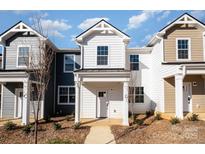 New construction townhome featuring a classic exterior with white siding and a covered front porch at 344 F Lincoln St, Concord, NC 28025