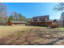 Sprawling home featuring an expansive front lawn, large porch, outbuilding, and ample parking at 529 Langley Rd, Lancaster, SC 29720