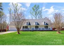 Charming home with a spacious front yard, covered porch, and attached garage at 705 Sagrada Dr, York, SC 29745