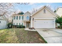Traditional two-story home featuring a front lawn and two-car garage at 10434 Henbane Ct, Charlotte, NC 28213