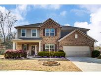 Charming two-story home features a brick facade, inviting entrance, manicured landscaping, and attached garage at 13240 Carolina Wren Ct, Charlotte, NC 28278