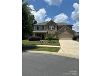 Charming two-story home with a manicured lawn, beautiful landscaping, and inviting curb appeal at 13240 Carolina Wren Ct, Charlotte, NC 28278