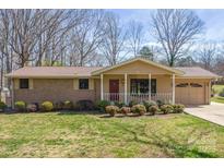 Charming single-story brick home with a cozy front porch and well-maintained landscaping at 1630 26Th Ne St, Hickory, NC 28601