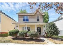 Charming two-story home featuring a welcoming front porch and well-maintained landscaping at 19613 Feriba Pl, Cornelius, NC 28031