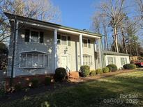 Traditional two-story home with large columns, shuttered windows, and well-maintained landscaping at 1968 12Th Street Ne Pl, Hickory, NC 28601