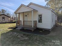 Charming single-story home with a cozy front porch, fresh landscaping, and recently painted exterior at 3703 Crawford St, Gastonia, NC 28052