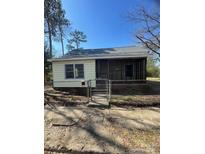 Charming single story home featuring a quaint, fenced front yard and screened porch at 529 Devine St, Chester, SC 29706