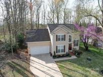 Charming two-story home with a well-maintained lawn and attached two-car garage in a wooded community at 8509 Piccone Brook Ln, Charlotte, NC 28216