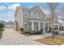 Charming two-story home with a detached garage and a cozy front porch at 11122 Aprilia Ln, Cornelius, NC 28031