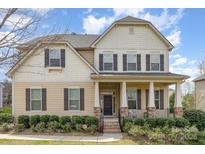 Charming two-story home featuring a welcoming porch and well-manicured landscaping at 2110 Capricorn Ave, Indian Trail, NC 28079