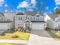 Beautiful two story home featuring a large two-car garage, manicured lawn, and traditional design elements at 8005 Rolling Wheels Rd, Charlotte, NC 28215