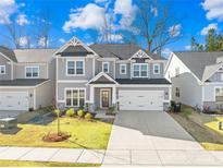 Beautiful two-story home featuring a two-car garage and well-manicured lawn in a friendly neighborhood at 8005 Rolling Wheels Rd, Charlotte, NC 28215