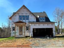 New construction home featuring a two-car garage and covered porch at 128 Kepli Way, Mooresville, NC 28115