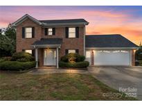 Charming two-story brick home with a two-car garage and manicured landscaping at 2082 Egret Ct, Rock Hill, SC 29732