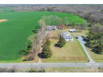 An aerial view shows a spacious home with a big green field in a beautiful, rural location at 4605 Austin Rd # 2, Monroe, NC 28112