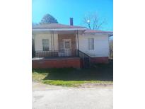 Modest single-story home with a small porch and railing at 544 3Rd St, Chester, SC 29706