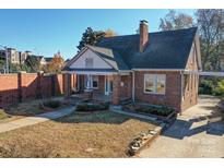 Charming brick home with well-kept lawn and mature trees, offering classic curb appeal and a welcoming ambiance at 610 Hawthorne Ln, Charlotte, NC 28204