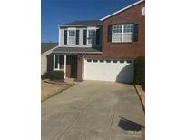 Charming two-story home with brick and gray siding, a well-maintained lawn, and a two-car garage at 8603 Westhope St, Charlotte, NC 28216