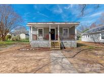 Charming home with a welcoming front porch and beautiful landscaping, great for curb appeal at 1001 Craven Ave, Kannapolis, NC 28083