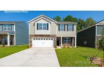 Charming two-story home with stone accents, a two-car garage, and a well-manicured lawn at 11135 Cardinal Creek Ave, Charlotte, NC 28215