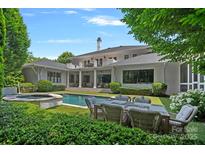 Stunning backyard featuring a pool, spa, outdoor seating, and lush landscaping at 19117 Davidson Concord Rd, Davidson, NC 28036