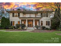 Elegant two-story home boasts classic architectural details, manicured lawn and a welcoming front entrance at 19117 Davidson Concord Rd, Davidson, NC 28036
