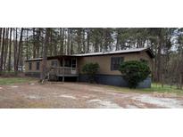 Cozy single-story home with a welcoming front porch and a treed front yard at 3748 Caribou Dr, Sherrills Ford, NC 28673