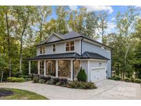 Charming two-story home with stone accents, a covered porch, and a well-maintained yard at 463 Lake Wylie Rd, Belmont, NC 28012
