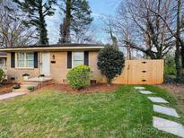 Charming brick home with a manicured lawn, landscaping and a welcoming entryway with steps at 4805 Horizon Cir, Charlotte, NC 28215
