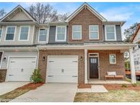 Charming brick townhome featuring a one-car garage and covered front porch at 6282 Tea Olive Dr # Lot 236, Harrisburg, NC 28075
