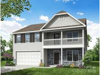 Charming two-story home with stone accents, white siding, a two-car garage, and inviting front porch and balcony at 1440 Ardmore Dr # 343, Sherrills Ford, NC 28673