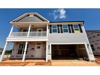 Charming two-story home featuring a welcoming front porch, two-car garage, and classic architectural details at 1440 Ardmore Dr # 343, Sherrills Ford, NC 28673
