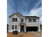 Two-story home featuring light siding, black shutters, an attached garage, and a welcoming front porch at 317 Maidstone Dr # 57, Monroe, NC 28110