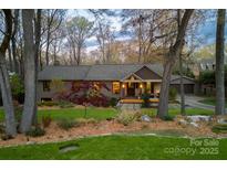 Charming exterior with mature trees, professional landscaping, and inviting front entrance at 4313 Kingswood Rd, Charlotte, NC 28226