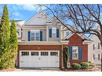 Charming brick and siding exterior with a two-car garage and blue shutters at 12124 Red Rust Ln, Charlotte, NC 28277