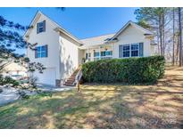 Charming two-story home with a manicured lawn, attached garage, and inviting front porch with stair access at 155 Gray Cliff Dr, Mooresville, NC 28117