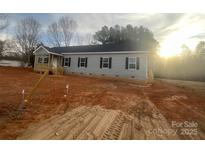 Charming single-story home with gray siding, black shutters, and a newly built wooden porch in a sunny neighborhood at 2070 Travis Rd, Conover, NC 28613