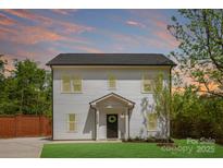 Modern two-story house with white siding and a well-maintained lawn, set against a vibrant sunset sky at 2544 Pinestream Dr, Charlotte, NC 28216