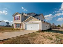 Charming two-story home features attached garage, and well-manicured lawn at 353 Webb Farm Rd, Shelby, NC 28152