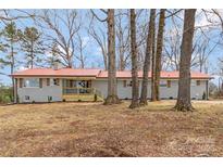 Charming single-story home with a red roof, grey siding, and natural wood accents at 4566 Fork Rd, Norwood, NC 28128