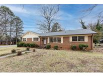 Charming one-story brick home featuring a well-maintained front yard and inviting entrance at 4601 Mendham Dr, Charlotte, NC 28215