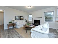 Inviting living room with comfortable furniture and a fireplace at 4601 Mendham Dr, Charlotte, NC 28215